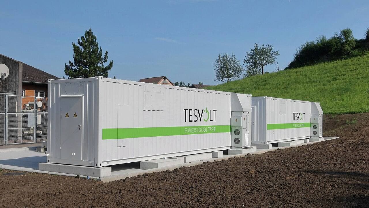 Row of battery energy storage system containers at a grid storage installation