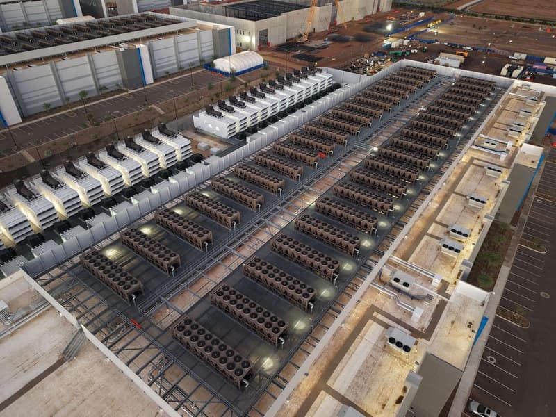 Aerial view of a data center roof with cooling towers and backup generators