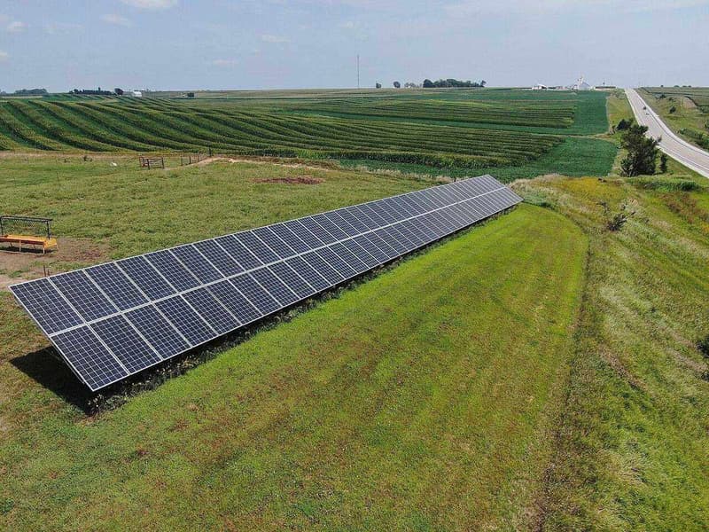 Rows of photovoltaic panels harvesting solar energy on a US farm field.