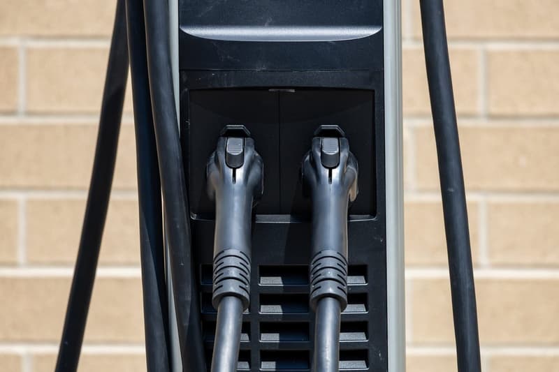 Close-up of two electric-vehicle charging handles on a public ChargePoint station.