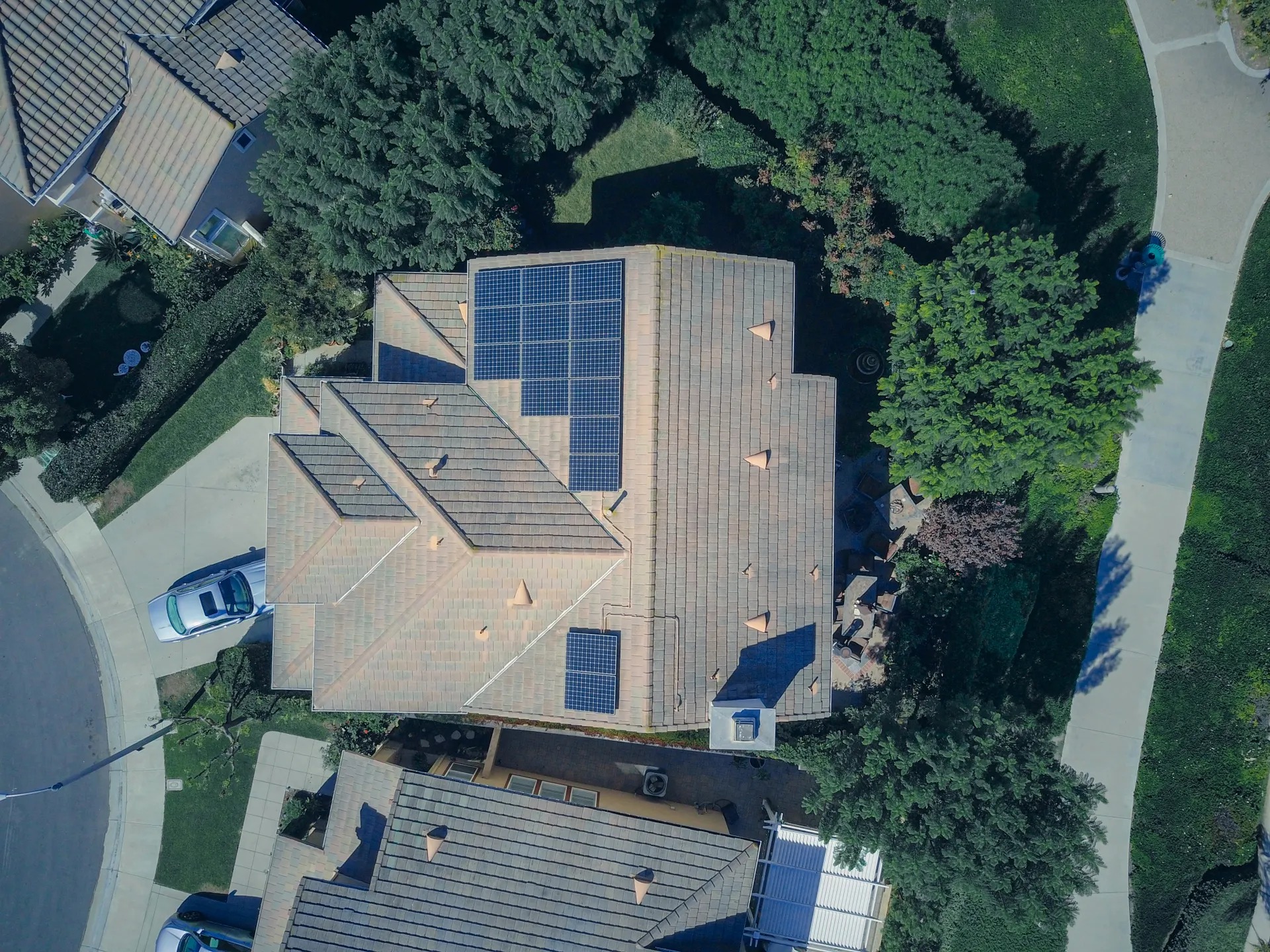 A suburban house with rooftop solar panels at dusk (illustrative image)