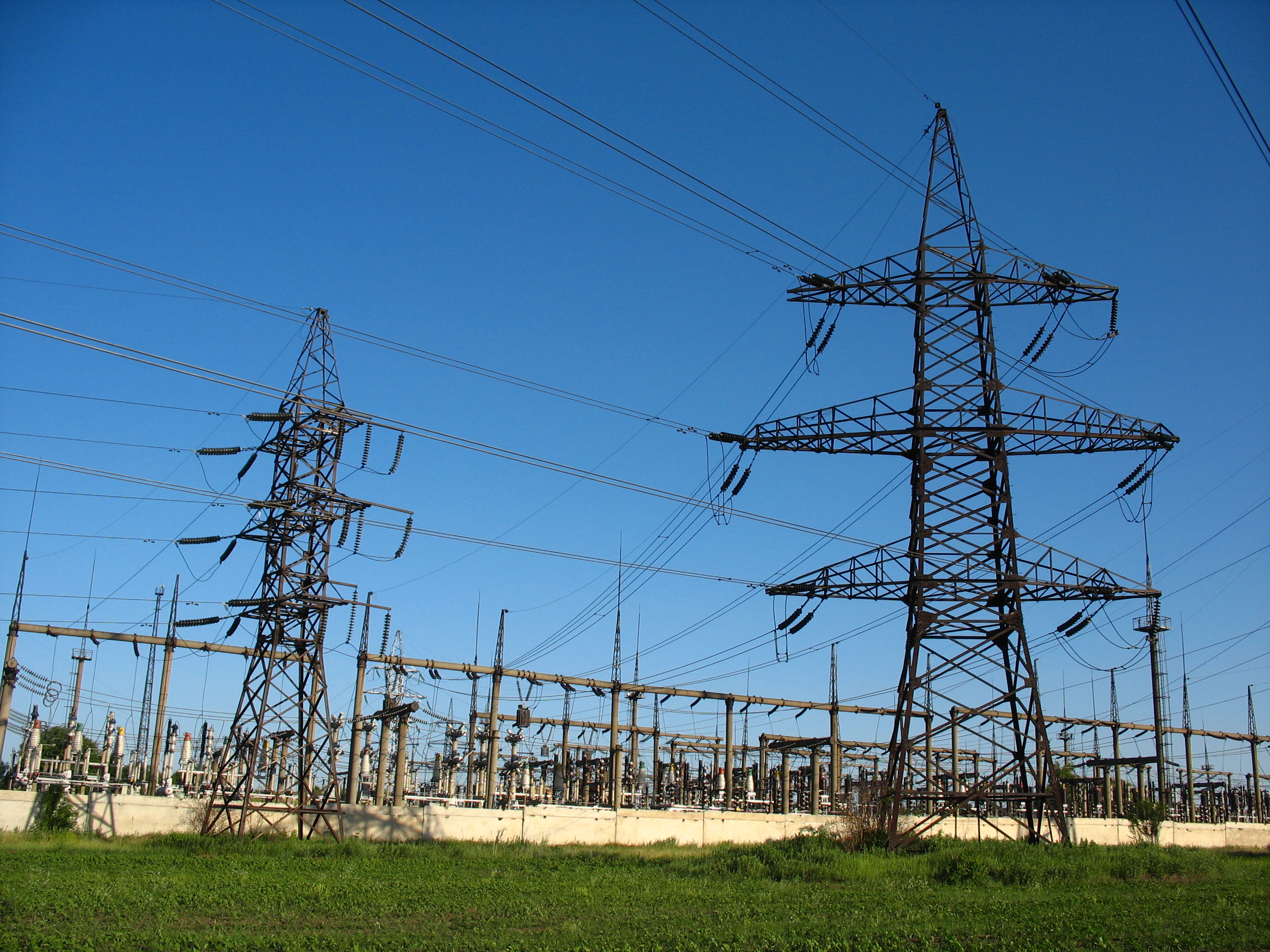 High-voltage electrical substation with transmission pylons (illustrative image)