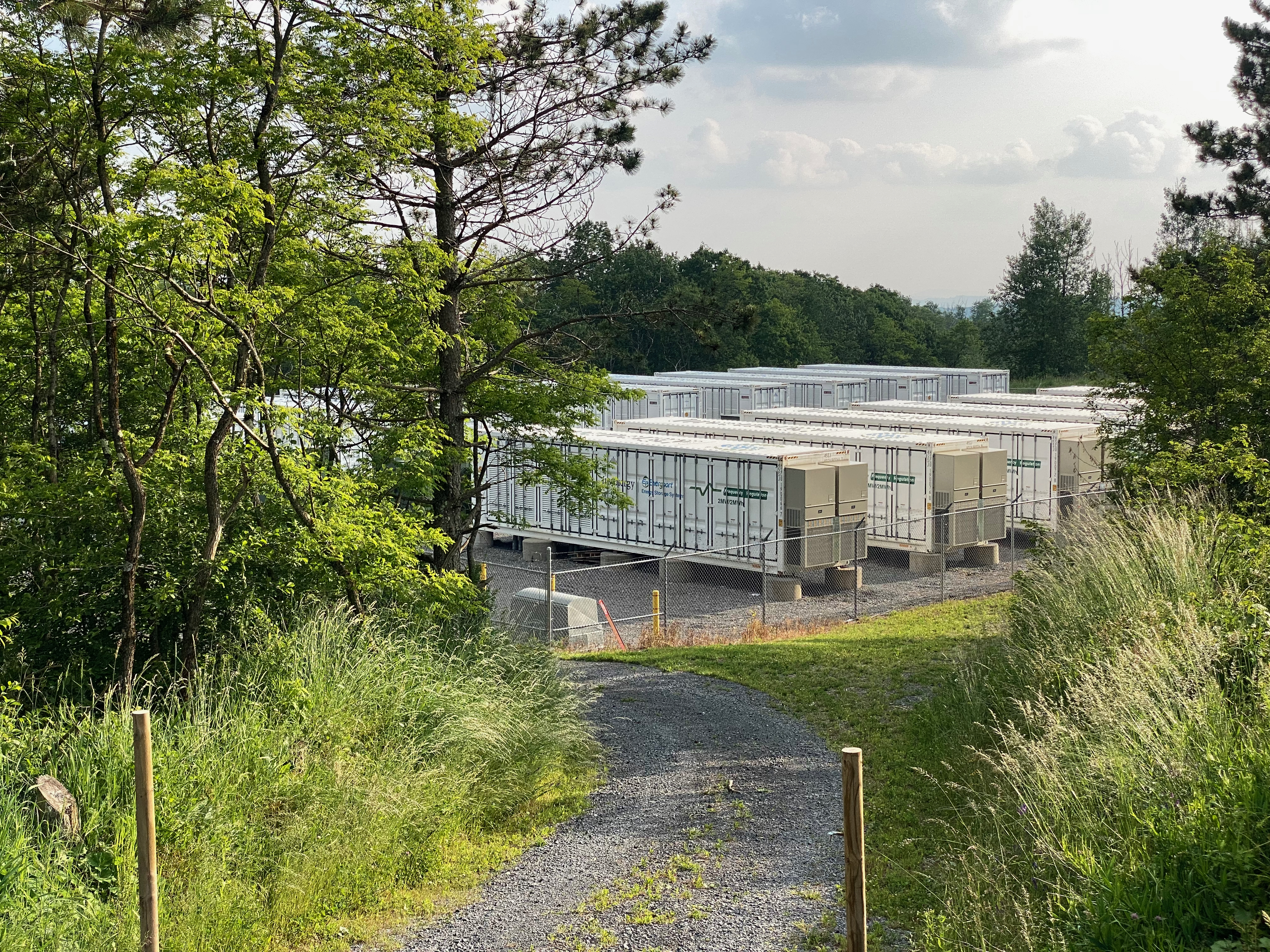 Battery energy storage containers at a grid-scale storage site (illustrative photo)